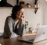 Young lady speaking via online conference tool on laptop