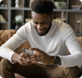 Young lad using phone for online conference